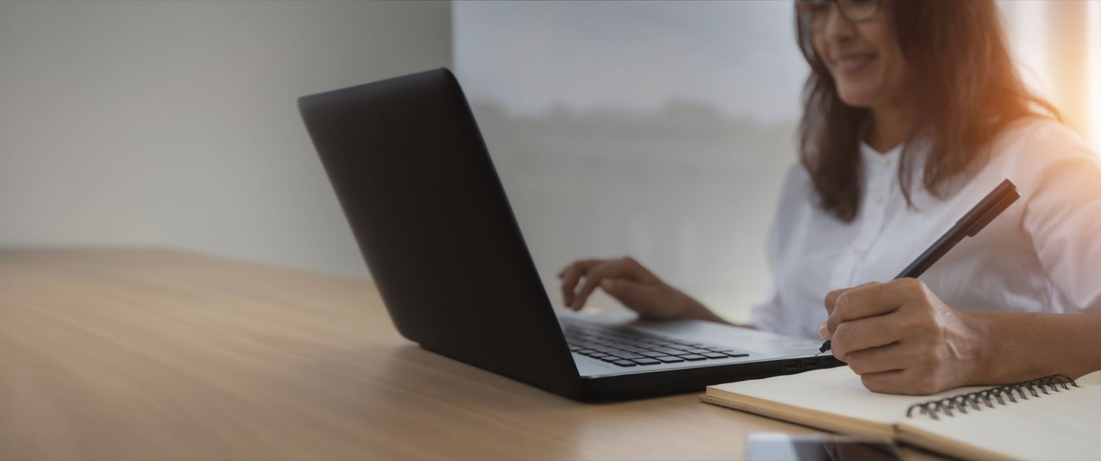 A teacher working at a laptop